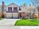 Charming two-story home boasts a well-manicured lawn and a welcoming two car garage at 2590 W Long Cir, Littleton, CO 80120