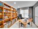 Well-lit home office with built-in bookshelves, a comfortable desk, and a serene atmosphere at 2590 W Long Cir, Littleton, CO 80120