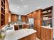 Modern kitchen with stainless steel appliances, quartz countertops, and wood cabinets at 2590 W Long Cir, Littleton, CO 80120