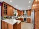 Modern kitchen with stainless steel appliances, quartz countertops, and wood cabinets at 2590 W Long Cir, Littleton, CO 80120