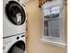 Convenient laundry area equipped with a modern washer/dryer set and natural light at 2590 W Long Cir, Littleton, CO 80120