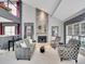 Inviting living room with a striking stone fireplace and large windows for natural light at 2590 W Long Cir, Littleton, CO 80120