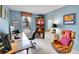 Comfortable home office with a large desk, stylish seating, and ample natural light at 2590 W Long Cir, Littleton, CO 80120
