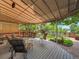 Inviting covered patio with ample seating and a manicured garden view for relaxing and entertaining at 2590 W Long Cir, Littleton, CO 80120