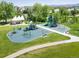 Aerial view of a vibrant park featuring a modern playground and lush green space at 2590 W Long Cir, Littleton, CO 80120
