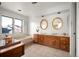 Elegant bathroom with double vanity, large mirrors, and a relaxing bathtub at 4530 S Verbena St # 309, Denver, CO 80237