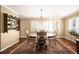 Charming dining room with hardwood floors, a wood table, and decorative wall shelves at 4530 S Verbena St # 309, Denver, CO 80237