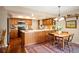 Eat-in kitchen with wood cabinets, a large island, and stainless steel appliances at 4530 S Verbena St # 309, Denver, CO 80237