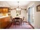 Cozy kitchen nook with a wooden table, sliding glass doors, and hardwood floors at 4530 S Verbena St # 309, Denver, CO 80237