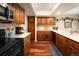 Modern kitchen with stainless steel appliances and ample wood cabinetry at 4530 S Verbena St # 309, Denver, CO 80237