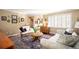 Elegant living room with hardwood floors, antique furniture, and large windows at 4530 S Verbena St # 309, Denver, CO 80237