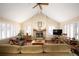 Bright living room with hardwood floors, a stone fireplace, and a vaulted ceiling at 4530 S Verbena St # 309, Denver, CO 80237