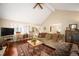 Open living room showcasing hardwood floors and views into the dining area and kitchen at 4530 S Verbena St # 309, Denver, CO 80237