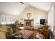 Spacious living room featuring a stone fireplace, hardwood floors, and abundant natural light at 4530 S Verbena St # 309, Denver, CO 80237