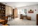 Home office with two desks, built-in shelving, and vintage wooden furniture at 4530 S Verbena St # 309, Denver, CO 80237