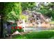 Serene backyard pond with waterfall and landscaping at 4530 S Verbena St # 309, Denver, CO 80237