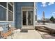 Backyard patio with seating leads to large wooden deck at 4290 Cottonwood Lakes Blvd, Thornton, CO 80241