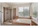Bright bathroom with a glass-enclosed shower and a separate soaking tub at 4290 Cottonwood Lakes Blvd, Thornton, CO 80241