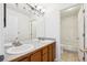 Bright bathroom featuring double sinks with a tiled countertop and a shower-tub combination at 4290 Cottonwood Lakes Blvd, Thornton, CO 80241