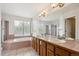 Primary bath with dual sinks, soaking tub, and large window offering natural light at 4290 Cottonwood Lakes Blvd, Thornton, CO 80241