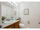 Cozy bathroom with classic tiles, a wooden vanity, and ample natural light at 4290 Cottonwood Lakes Blvd, Thornton, CO 80241