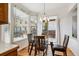 Cozy dining area with a glass table, wood chairs, and views of the backyard at 4290 Cottonwood Lakes Blvd, Thornton, CO 80241
