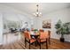 Inviting dining area with a wood table, colorful chairs, and an open view into the living room at 4290 Cottonwood Lakes Blvd, Thornton, CO 80241