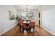 Charming dining room with hardwood floors, a modern chandelier, and cozy seating for six at 4290 Cottonwood Lakes Blvd, Thornton, CO 80241
