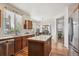 Well-lit kitchen with wood cabinets, center island, and many windows to let in natural light at 4290 Cottonwood Lakes Blvd, Thornton, CO 80241