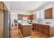 Bright kitchen featuring wood cabinets, an island, and stainless steel appliances at 4290 Cottonwood Lakes Blvd, Thornton, CO 80241