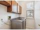 Efficient laundry room with a modern washer and dryer set and wooden cabinets at 4290 Cottonwood Lakes Blvd, Thornton, CO 80241