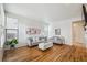 Bright living room featuring hardwood floors, modern sofas, and natural light at 4290 Cottonwood Lakes Blvd, Thornton, CO 80241