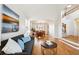 Open-concept living area with wood floors, stylish decor, and seamless transition to the dining area at 4290 Cottonwood Lakes Blvd, Thornton, CO 80241