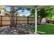 Backyard featuring lush greenery, gravel, and a wooden fence, creating a private outdoor space at 7325 S Houstoun Waring Cir, Littleton, CO 80120