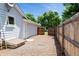Backyard with gravel area, wooden fence, and access gate at 7325 S Houstoun Waring Cir, Littleton, CO 80120