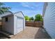 Backyard featuring gravel area, wooden fence, and gray storage shed at 7325 S Houstoun Waring Cir, Littleton, CO 80120