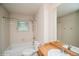 Bright bathroom with a large tub and shower combination, and wood-look vanity at 7325 S Houstoun Waring Cir, Littleton, CO 80120