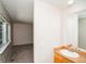 Bright bathroom featuring a white vanity and sink, large mirror, and neutral wall color at 7325 S Houstoun Waring Cir, Littleton, CO 80120