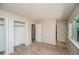 Bedroom with large window, closet, and tile flooring to adjacent bathroom at 7325 S Houstoun Waring Cir, Littleton, CO 80120