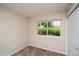 Bright bedroom featuring a large window with lush greenery and ample closet space at 7325 S Houstoun Waring Cir, Littleton, CO 80120