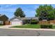 Charming ranch-style home featuring a well-maintained lawn and a two-car attached garage at 7325 S Houstoun Waring Cir, Littleton, CO 80120