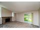 Spacious living room with a brick fireplace and sliding glass door to the backyard at 7325 S Houstoun Waring Cir, Littleton, CO 80120