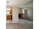 Open living room featuring a brick fireplace, large windows, and seamless transition to the kitchen at 7325 S Houstoun Waring Cir, Littleton, CO 80120