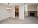Cozy living room and kitchen area with brick fireplace and open floor plan at 7325 S Houstoun Waring Cir, Littleton, CO 80120