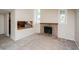 Bright living room showcasing a brick fireplace, neutral walls, and an open layout at 7325 S Houstoun Waring Cir, Littleton, CO 80120