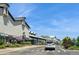 The street shows a pedestrian crossing with a line of shops on one side on a clear, sunny day at 7325 S Houstoun Waring Cir, Littleton, CO 80120