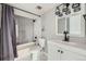 Modern bathroom features a shower, tub, and white vanity with black fixtures at 15350 E Arizona Ave # 308, Aurora, CO 80017