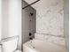 Bathroom boasts a modern shower and tub with gray and marble-look tile surround at 15350 E Arizona Ave # 308, Aurora, CO 80017