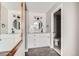 Bright bathroom features a white vanity, round mirror, and tiled shower with modern fixtures at 15350 E Arizona Ave # 308, Aurora, CO 80017