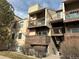 Tan two-story condo building with balconies and stairs at 15350 E Arizona Ave # 308, Aurora, CO 80017